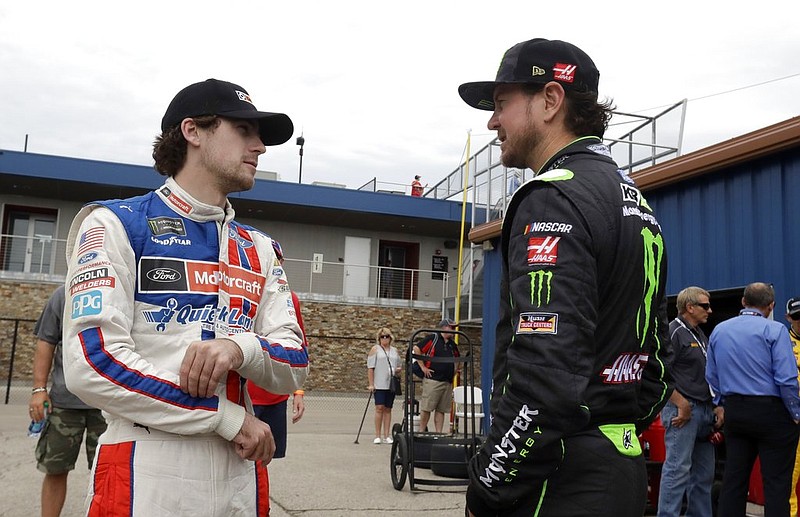 Ryan Blaney, left, talks with Kurt Busch before a practice session, Saturday, June 17, 2017, for the NASCAR Sprint Cup series auto race in Brooklyn, Mich. 
