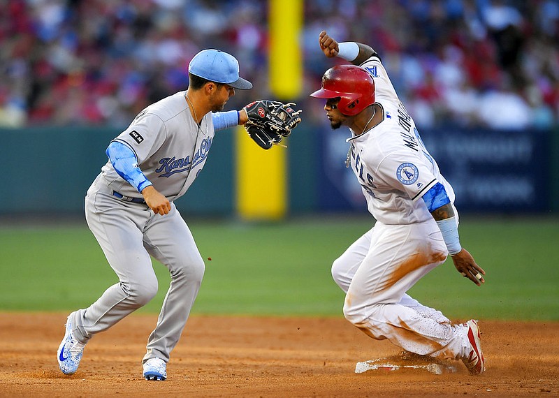 Los Angeles Angels' Martin Maldonado, right, is tagged out at second by Kansas City Royals second baseman Whit Merrifield while trying to steal during the sixth inning of a baseball game, Saturday, June 17, 2017, in Anaheim, Calif. 