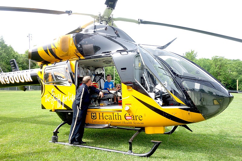 Pilot Ted Clemons, left, teaches Colton Lewis about piloting a helicopter during the Fulton Street Fair Touch-a-Truck event on Saturday, June 17, 2017.