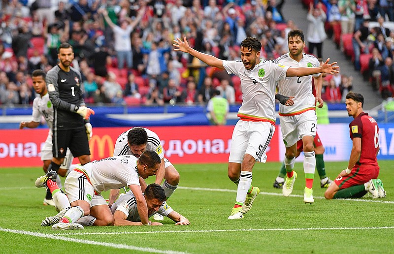 Mexico's Hector Moreno, center, celebrates after scoring his side's second goal during the Confederations Cup, Group A soccer match between Portugal and Mexico, at the Kazan Arena, Russia, Sunday, June 18, 2017. 