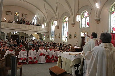 The Rev. Joseph Corel, vicar general for the Roman Catholic Diocese of Jefferson City, elevates the Eucharist during a Mass on Saturday, June 17, 2017, to celebrate the 150th anniversary of the founding of Visitation of the Blessed Virgin Mary parish and the 125th anniversary of the founding of Visitation Inter-Parish School, both in Vienna.