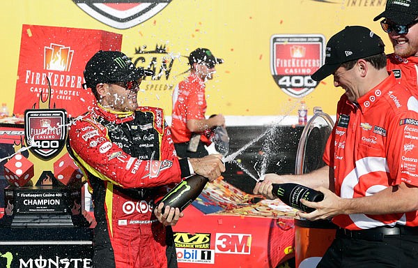 Kyle Larson is sprayed with a sports drink after winning the NASCAR Cup series race Sunday in Brooklyn, Mich.