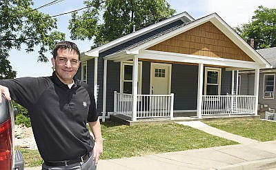 Charlie Frank poses in front of a house he has spent the last two years working on. He was able to access money from a Jefferson City program to repair rental properties to make them more feasible to rent. 