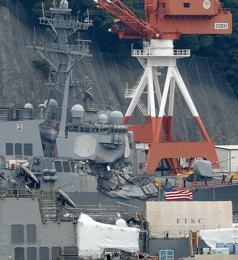 Damaged USS Fitzgerald is seen at Yokosuka Naval Base, south of Tokyo, Sunday, June 18, 2017.  Navy divers found the bodies of missing sailors Sunday aboard the stricken USS Fitzgerald that collided with a container ship Saturday in the busy sea off Japan, the Navy said.