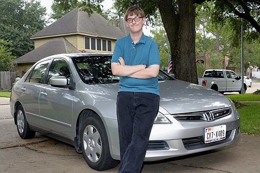 In this May 26, 2017, photo, Parker Peddicord stands in front of his car in Katy, Texas. The Safeway Driving school, a franchise with a location in Katy, offered training specific to people with special needs arising from conditions such as attention deficit hyperactivity disorder. Parker enrolled about two years ago when he was 16. 