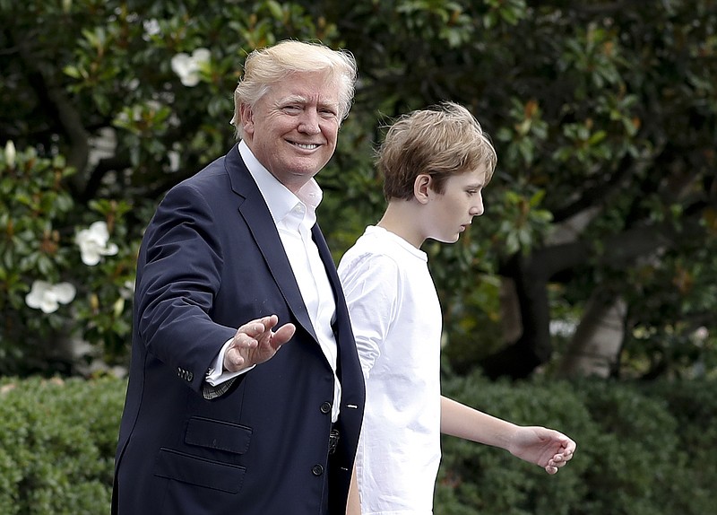 President Donald Trump and his son Barron Trump walk to Marine One across the South Lawn of the White House in Washington, Saturday, June 17, 2017, en route to Camp David in Maryland. 