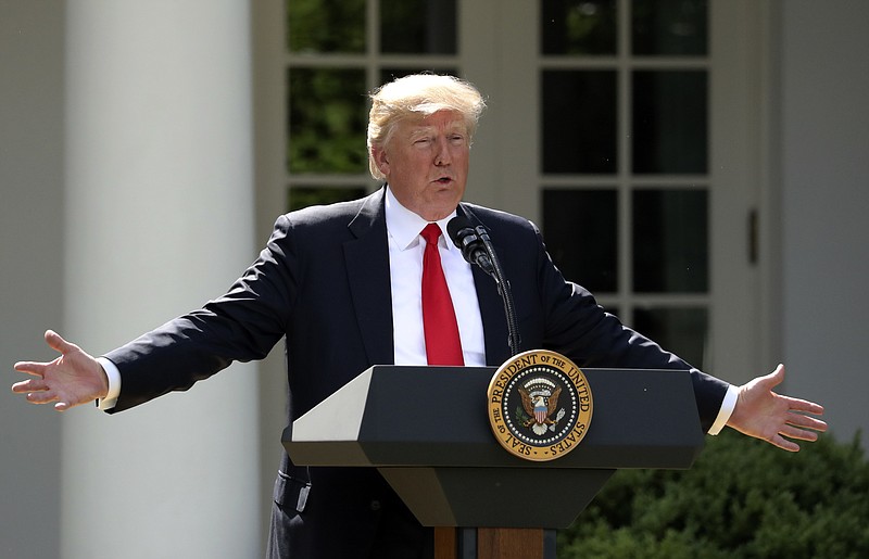 FILE - In this June 1, 2017, file photo, President Donald Trump speaks about the U.S. role in the Paris climate change accord in the Rose Garden of the White House in Washington. A new poll finds that less than a third of Americans support Trump’s decision to withdraw from the Paris climate accord, with just 18 percent of respondents agreeing with his claim that pulling out of the international agreement to reduce carbon emissions will help the U.S. economy.(AP Photo/Andrew Harnik, File)