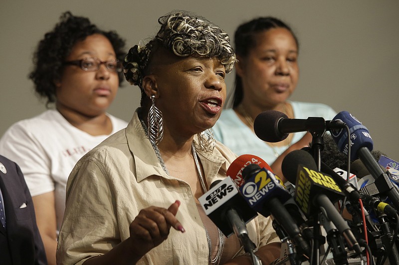 FILE- In this July 14, 2015, file photo, Eric Garner's mother Gwen Carr, center, is joined by his daughter Emerald Snipes, left, and wife Esaw Snipes, as she speaks during a news conference in New York. The family of Eric Garner, an unarmed black man killed by a police chokehold, is set to meet with Department of Justice officials with the outcome of the high-profile federal investigation of the case still unknown, the department confirmed Tuesday, June 20, 2017. (AP Photo/Mary Altaffer, File)