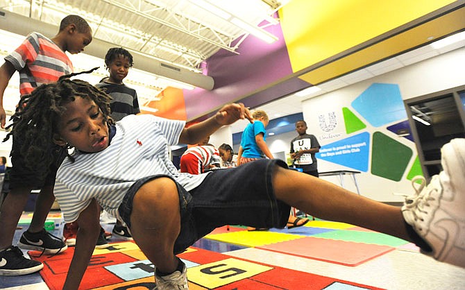 Danjelo Johnson, 7, dances while playing hopscotch on Monday during the Boys & Girls Club grand opening.