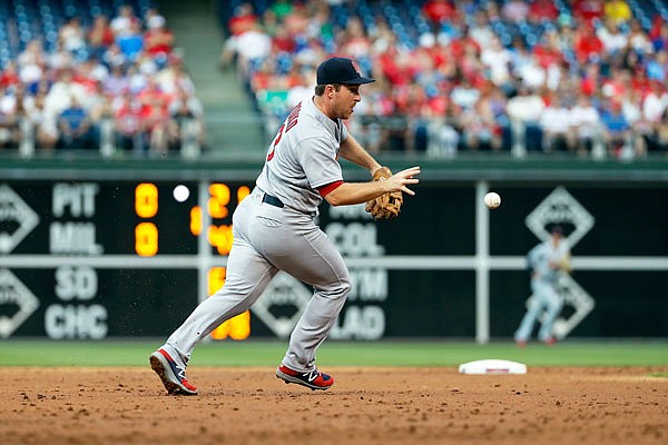 Cardinals third baseman Jedd Gyorko reaches to bare hand a grounder during Tuesday night's game against the Phillies in Philadelphia.