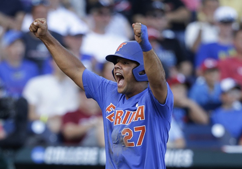 Florida'a Nelson Maldonado celebrates after he scored on a three-run home run by Deacon Liput during the fourth inning of an NCAA College World Series baseball game against Louisville in Omaha, Neb., Tuesday, June 20, 2017. 