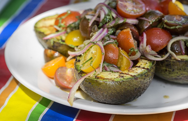 The avocado halves were brushed with mayonnaise, salt and pepper, then topped with marinated tomato salad.  