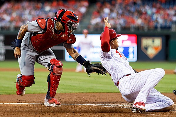 Cardinals catcher Yadier Molina tags out Aaron Altherr of the Phillies as Altherr tried to score on a single by Tommy Joseph during the fourth inning of Wednesday night's game in Philadelphia.