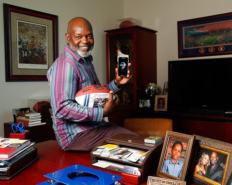 In this May 24, 2017 photo, Dallas Cowboys' Hall of Fame running back Emmitt Smith poses with a football with a Legit chip, an embeddable NFC chip which can be used to verify sports memorabilia or even luxury items at his Addison, Texas office. Smith's Prova Group has come up with the tech-enabled way to legitimize sports memorabilia, celebrity signatures and luxury goods. The company embeds a chip into the products, which can be scanned for more information about that item. 