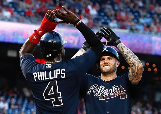 Braves first baseman Matt Adams celebrates with teammate Brandon Phillips after hitting a three-run homer during a game earlier this month against the Nationals in Washington.