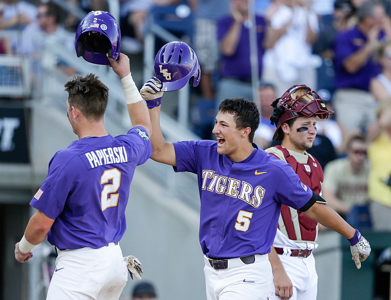 LSU's Jake Slaughter (5) celebrates his three-run home run in the second inning of an NCAA College World Series baseball game against Florida State in Omaha, Neb., Wednesday, June 21, 2017, with Michael Papierski (2), who also scored on the play, as Florida State catcher Cal Raleigh stands at right.