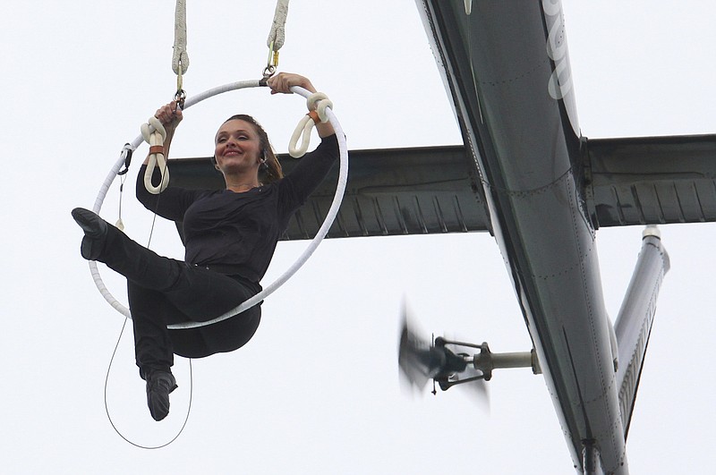 Erendira Wallenda performs a series of acrobatic maneuvers, including hanging by her teeth, while suspended from a helicopter Thursday, June 15, 2017, above Niagara Falls in Niagara Falls, N.Y. The aerialist wife of daredevil Nik Wallenda spent about eight minutes of the 10-minute stunt hovering over the falls.