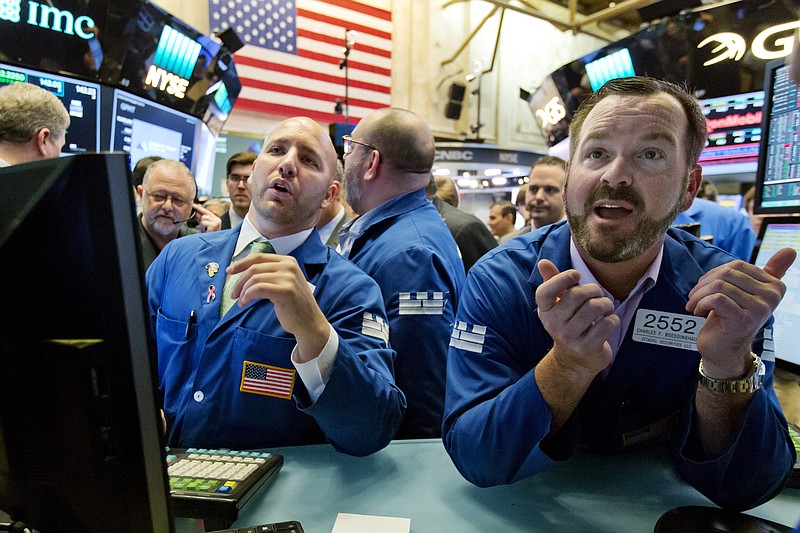 Specialists John Parisi, left, and Charles Boeddinghaus work on the floor of the New York Stock Exchange, Friday, June 23, 2017. U.S. stock indexes inched higher Friday as energy companies clawed back some of their sharp losses from earlier in the week. (AP Photo/Richard Drew)