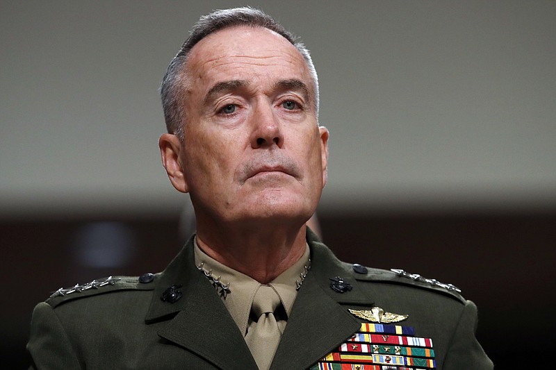 FILE - In this June 13, 2017, file photo. Joint Chiefs Chairman Gen. Joseph Dunford listens on Capitol Hill in Washington. Military chiefs will seek a six-month delay before letting transgender people enlist in their services, officials said June 23. Dunford told a Senate committee there have been some issues identified with recruiting transgender individuals that “some of the service chiefs believe need to be resolved before we move forward.” He said Mattis was reviewing the matter. (AP Photo/Jacquelyn Martin, File)