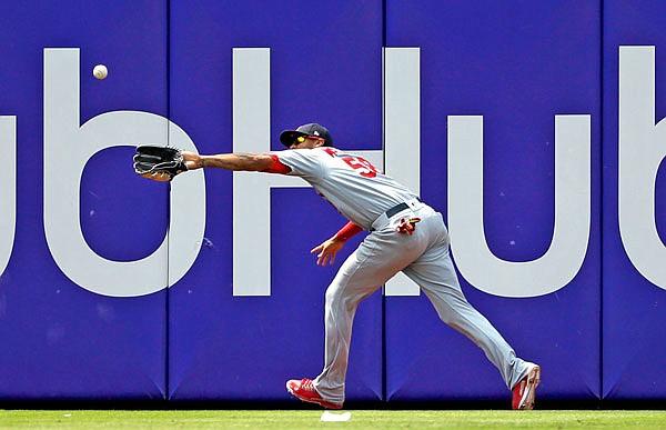 Cardinals left fielder Jose Martinez tries to catch a ball hit by Odubel Herrera of the Phillies during the eighth inning of Thursday afternoon's game in Philadelphia. Herrera reached second on the error.