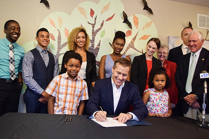 In a Thursday morning ceremony at the Central Missouri Foster Care & Adoption Association's office in Jefferson City, Gov. Eric Greitens signed the Foster Care Bill of Rights into law, which makes changes to the state's child protection laws.