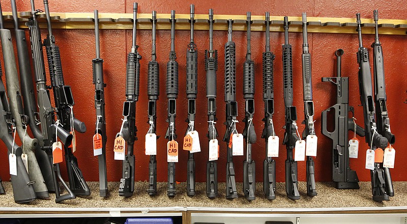 This June 27, 2013 file photo shows a rack of rifles at Firing-Line gun store in Aurora, Colo.  A new survey by the Pew Research Center shows Americans have grown more divided over gun issues. The survey of adults showed about half favor gun-control measures while about half support preserving gun rights. The results underscore the divide in the United States along political, racial, gender and geographic lines. 