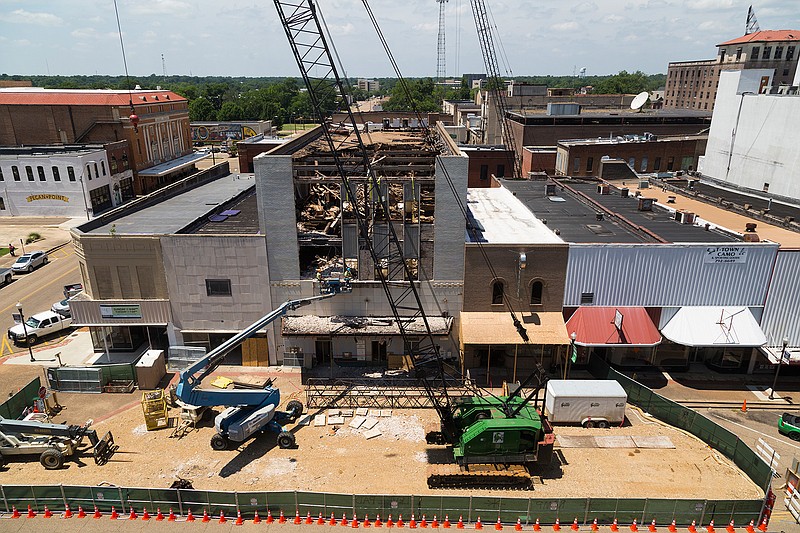 Workers chisel out pieces of the facade of the Kress Building on Thursday in downtown Texarkana, Texas. The original building burned in 1933 and was rebuilt to house the distinct five-and-dime store and was later condemned in 1979. In October 2012, the City Council deemed the building unsafe and began the process to have it condemned. A Joplin, Mo., firm is doing the work.
