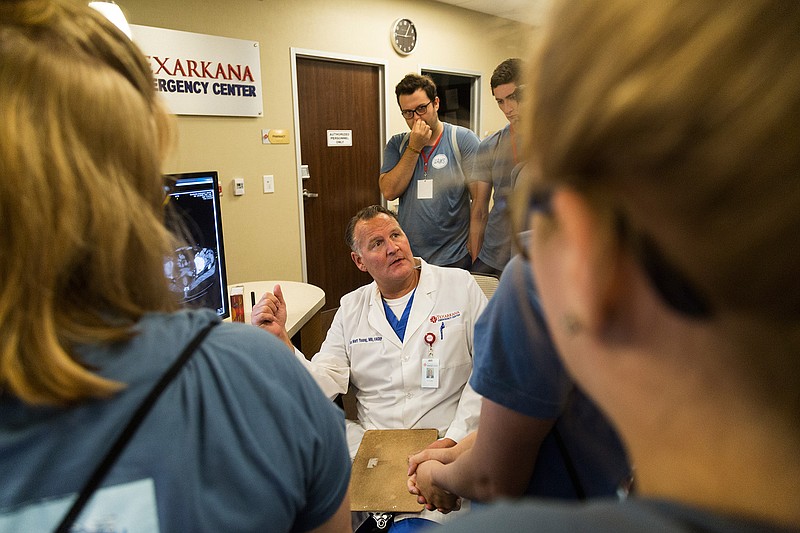 Dr. Matt Young shows students in the UAMS Southwest M*A*S*H program scans of the human body on Thursday at Texarkana Emergency Center.