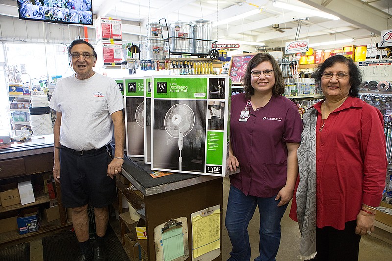 Vinod and Bhagvati Doolabh present Katie Stone with Encompass Hospice 45 pedestal fans to be given out to local hospice patients. This is the 10th year the owners of General Supply on Spruce Street in Texarkana, Texas, have given fans to the needy.   