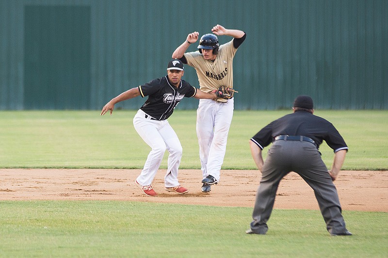 The Texarkana Twins Alex Rodrigez tags out Texas Marshals Jarrod Huber after chasing him down between first and second on Friday at George Dobson Field.