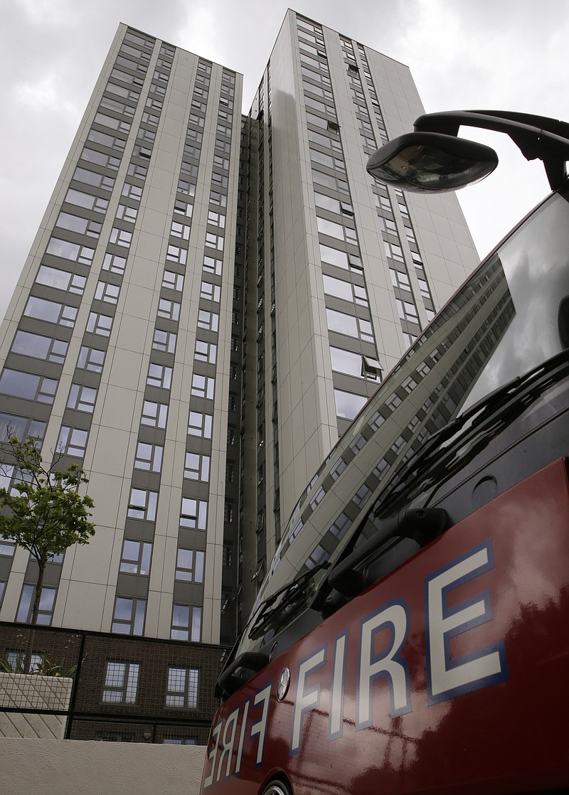 A fire engine is parked outside Burnham block, part of the Chalcots Estate in the borough of Camden, north London, Saturday June 24, 2017, after the local council evacuated some 650 homes overnight. The apartments were evacuated overnight after fire inspectors concluded that the buildings, in north London's Camden area, were unsafe because of problematic fire doors, gas pipe insulation, and external cladding similar to that blamed for the rapid spread of a fire that engulfed Grenfell Tower on June 14. (AP Photo/Alastair Grant)