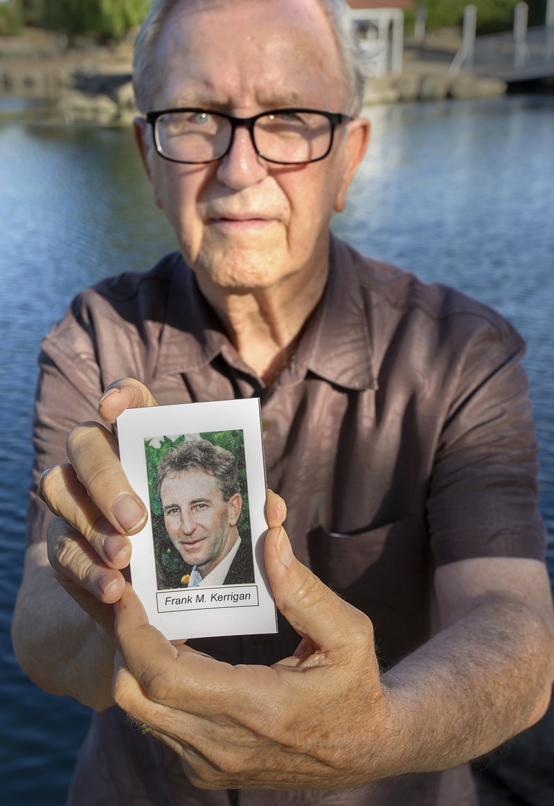 In this Friday, June 23, 2017 photo, Frank Kerrigan holds onto a a funeral card for his son Frank, near Wildomar, Calif. Kerrigan, who thought his son had died, learned he buried the wrong man. Kerrigan said the Orange County coroner's office mistakenly identified a body found dead on May 6 as that of his son. (Andrew Foulk/The Orange County Register via AP)