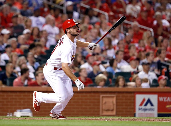 Paul DeJong of the Cardinals watches his solo home run during the seventh inning of Friday night's game against the Pirates at Busch Stadium.