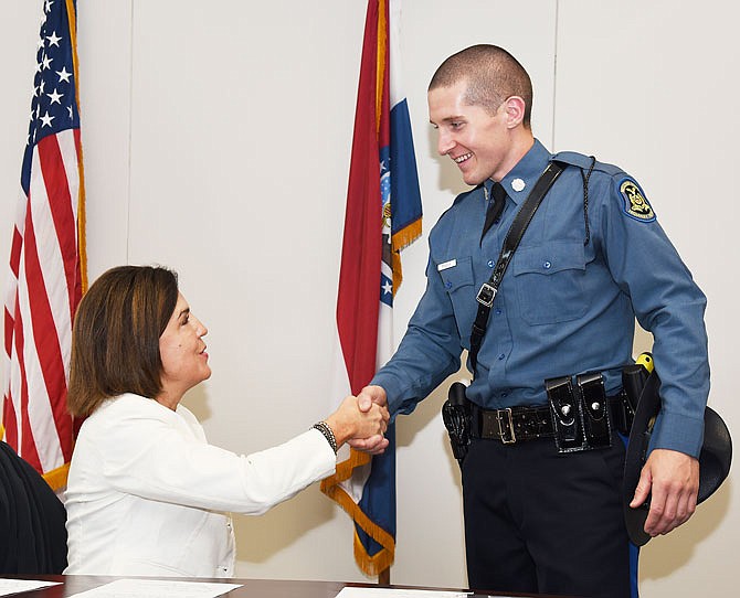 After swearing in the new troopers during Friday's graduation of the Missouri Highway Patrol's 104th Class, Judge Mary Russell greeted and visited briefly with each of the 27 troopers, including Brant Masek, of Fulton, shown here shaking hands with the Missouri Supreme Court justice.