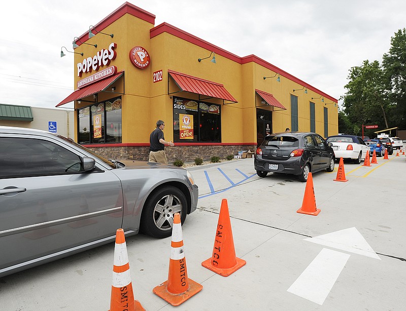 Mikala Compton/News Tribune
Cars line up in the drive-thru at the new Popeyes off Missouri Boulevard in Jefferson City on Thursday, June 22, 2017. The restaurant opened on Monday, June 19, 2017. Cones were set up and employees were stationed outside to direct traffic through the crowded line.