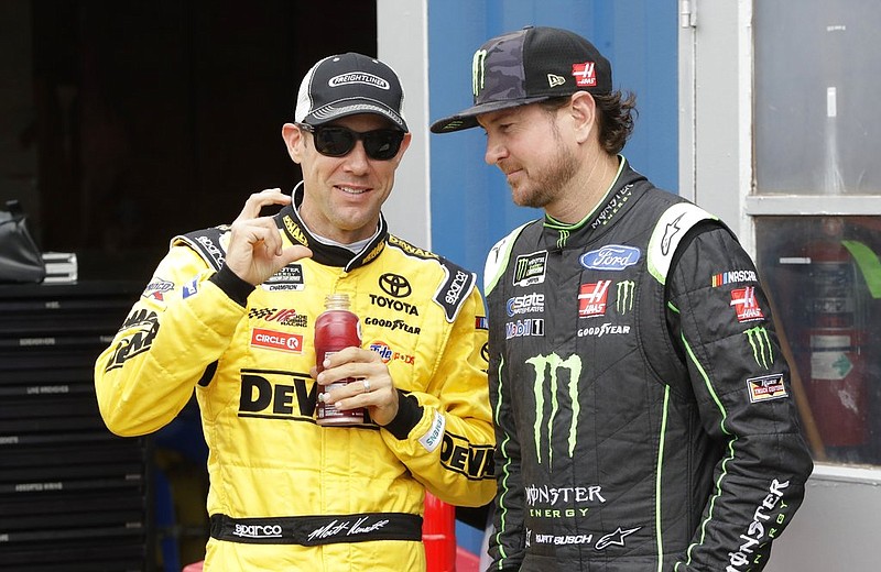 Matt Kenseth, left, talks with Kurt Busch before a practice session, Saturday, June 17, 2017, for the NASCAR Cup series auto race in Brooklyn, Mich. 