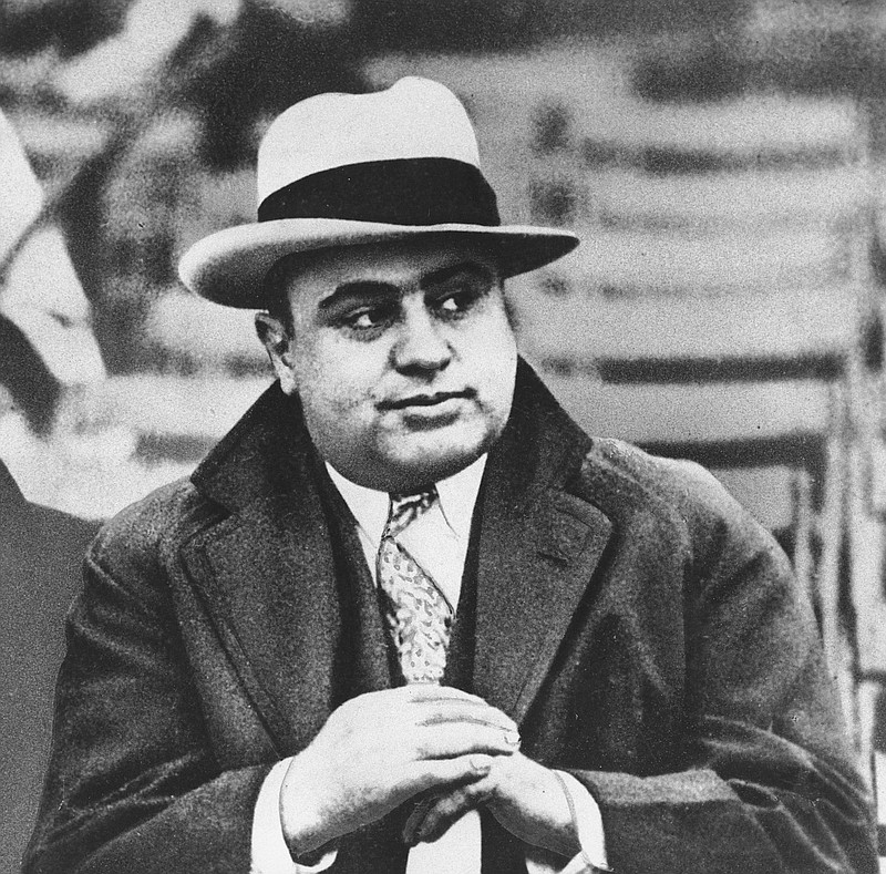 In this Jan. 19, 1931 file photograph, Chicago mobster Al Capone is seen at a football game in Chicago. Artifacts connected to some of the nation's most notorious gangsters are being auctioned this weekend. A handwritten musical composition by Al Capone, a letter written by a jailed John Gotti asking someone to "keep the martinis cold," and jewelry that belonged to Bonnie and Clyde are among the items up for bid Saturday in the "Gangsters, Outlaws and Lawmen" auction in Cambridge, Mass.