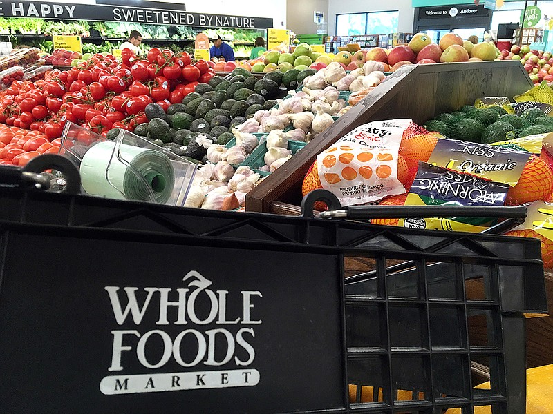 This June 5, 2017, photo, shows produce displayed at Whole Foods Market in Andover, Mass. Amazon is buying Whole Foods in a deal valued at about $13.7 billion. The two companies have not yet detailed how their proposed union might change the experience for customers. But the deal has the potential to boost the outsized ambitions of Amazon CEO Jeff Bezos and Whole Foods chief John Mackey, each of whom has already radically altered the way Americans shop.