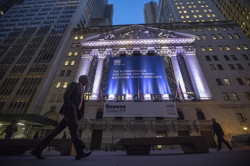 FILE - In this Tuesday, Oct. 25, 2016, file photo, a pedestrian walks past the New York Stock Exchange, in lower Manhattan. Technology and consumer-focused companies are leading stocks higher in early trading on Wall Street, Monday, June 26, 2017. (AP Photo/Mary Altaffer, File)