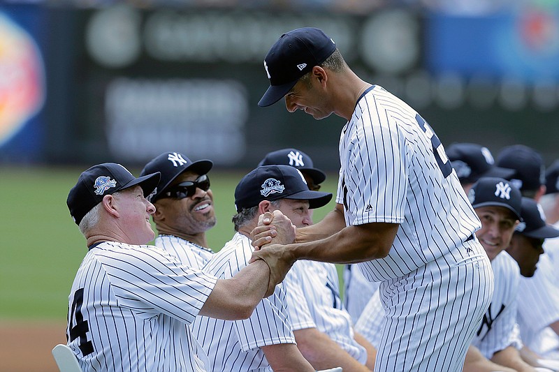 Former New York Yankee Jorge Posada, front right, shakes hands with other former players during Old-Timers' Day at Yankee Stadium, Sunday, June 25, 2017, in New York. 