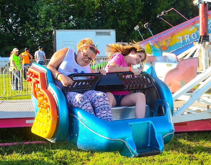 Teenagers ride "The Sizzler" at the 2016 Miller County Fair.