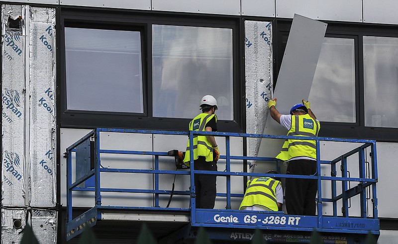 <p>AP</p><p>Workers remove cladding Monday from Whitebeam Court, in Pendleton, Manchester. The list of high-rise apartment towers in Britain that have failed fire safety tests grew to 60, officials said, revealing the mounting challenge the government faces in the aftermath of London’s Grenfell Tower fire tragedy.</p>