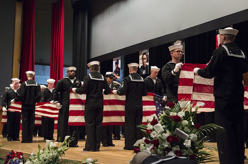 In this photo released by U.S. Navy, sailors fold seven U.S. flags during a memorial ceremony at Fleet Activities (FLEACT) Yokosuka, south of Tokyo, Tuesday, June 27, 2017, for seven sailors assigned to USS Fitzgerald who were killed in the June 17 collision. The U.S. Navy has paid tribute to the sailors killed as their warship collided with a merchant ship off Japan this month. The USS Fitzgerald and the Philippine-flagged container collided in the Japanese waters off Yokosuka in the pre-dawn hours of June 17. (Mass Communication Specialist 2nd Class Raymond D. Diaz III/U.S. Navy via AP)