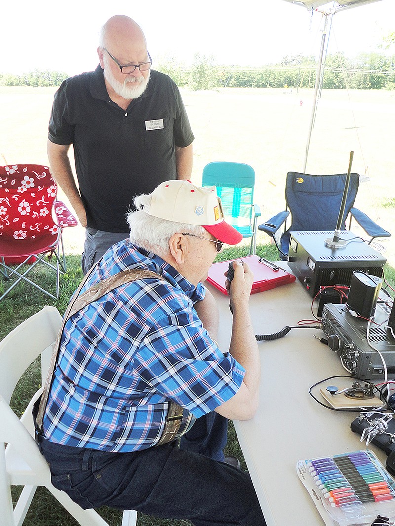 During the National Amateur Radio Field Day event in Kingdom City last weekend, members of the Callaway Amateur Radio League and Callaway Emergency Communications, Inc. tested their disaster readiness. Here, CARL President Ken Sevier (standing) and member Harold "Dick" Thompson attempt to make connections with other operators across the country.