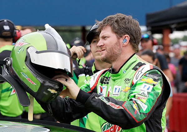 Dale Earnhardt Jr. reaches for his helmet before qualifying for a NASCAR Sprint Cup series race earlier this month in Brooklyn, Mich.