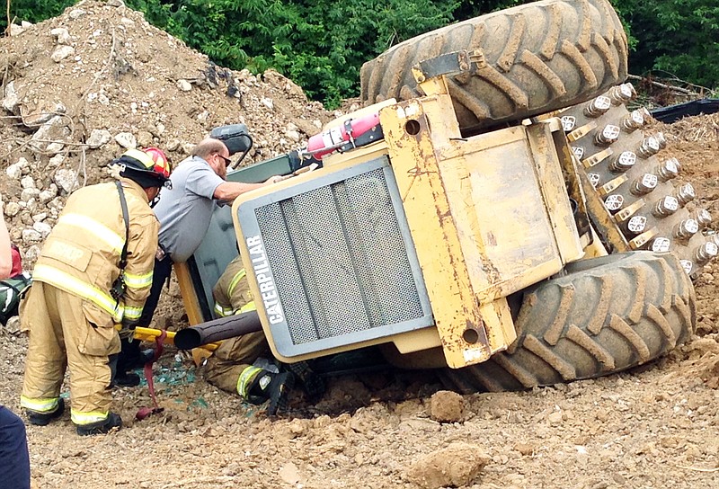 <p>Jerry Blomberg/Jefferson City Fire Department</p><p>Firefighters respond to a call for extrication Wednesday morning at a construction site off of Hayselton Drive after a soil compactor overturned with the operator inside.</p>
