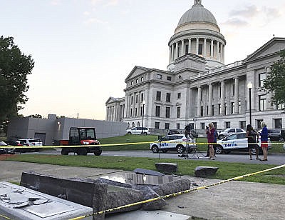 The new Ten Commandments monument outside the state Capitol in Little Rock, Ark., is blocked off Wednesday morning, June 28, 2017, after someone crashed into it with a vehicle, less than 24 hours after the privately funded monument was placed on the Capitol grounds. Authorities arrested a male suspect.