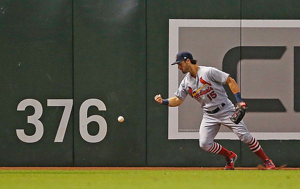 Cardinals left fielder Randal Grichuk tries to gets control of a fly ball double hit over his head by the Diamondbacks' Daniel Descalso during the fourth inning of Tuesday night's game in Phoenix.
