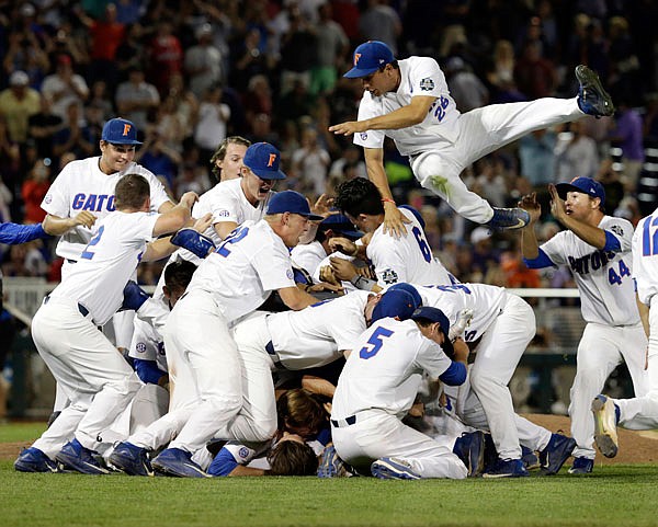 Florida players, including center fielder Nick Horvath (top right), celebrate after defeating LSU in Game 2 to win the NCAA College World Series on Tuesday night in Omaha, Neb.
