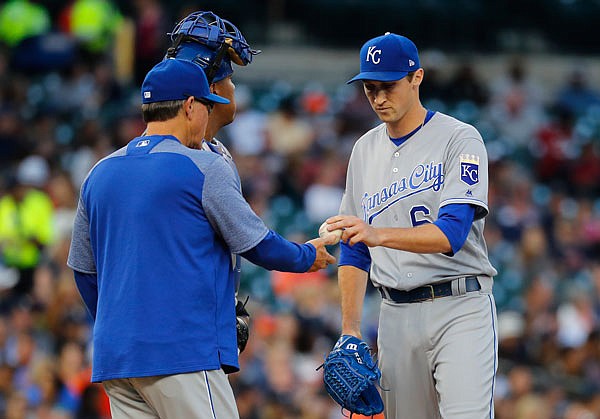 Kansas City Royals manager Ned Yost (left) takes the ball from pitcher Matt Strahm during the fourth inning of Tuesday night's game against the Tigers in Detroit.